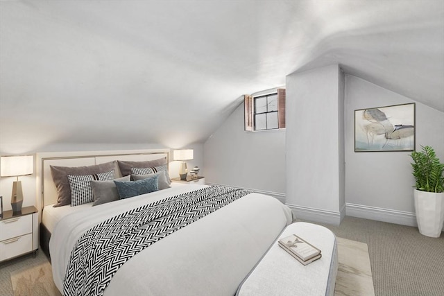 bedroom with light colored carpet and lofted ceiling