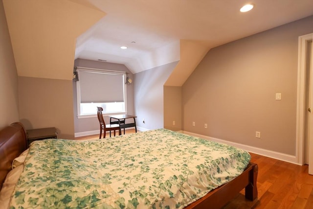 bedroom featuring lofted ceiling, recessed lighting, dark wood finished floors, and baseboards