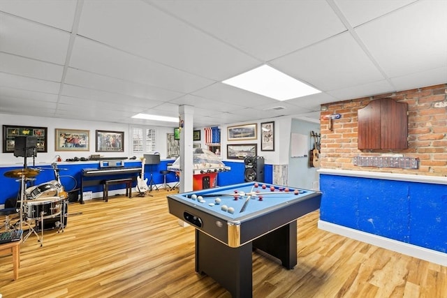 playroom with a drop ceiling and wood finished floors