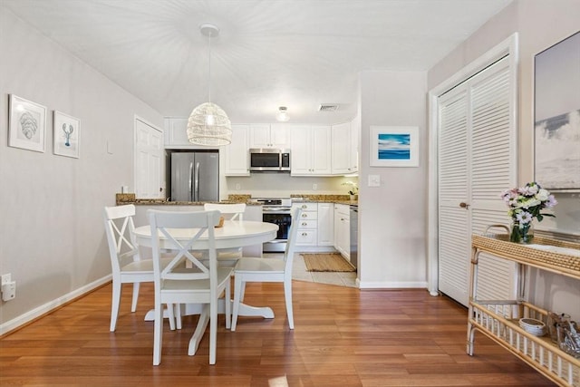 2 Englewood Dr Unit F-6, Harwich, MA 02645 - dining area featuring light wood-type flooring and baseboards