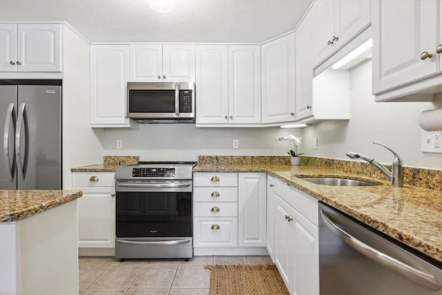 2 Englewood Dr Unit F-6, Harwich, MA 02645 - kitchen featuring stainless steel appliances, light tile patterned flooring, and white cabinets