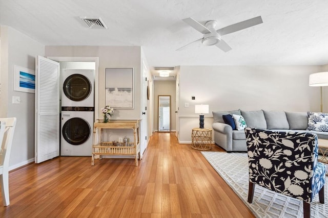 2 Englewood Dr Unit F-6, Harwich, MA 02645 - living area featuring stacked washer / dryer, light wood-style floors, and ceiling fan
