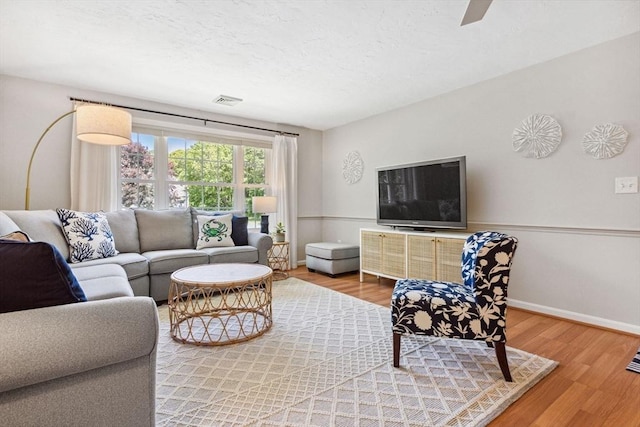 2 Englewood Dr Unit F-6, Harwich, MA 02645 - living room featuring wood finished floors and a textured ceiling