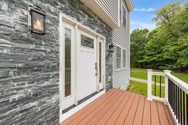 24 Clark St, Taunton, MA 02780 - doorway to property with stone siding, a lawn, and a wooden deck