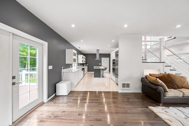 24 Clark St, Taunton, MA 02780 - living room with light wood-style flooring, stairs, recessed lighting, and baseboards