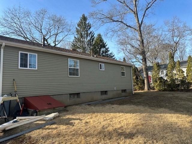 rear view of property featuring a yard