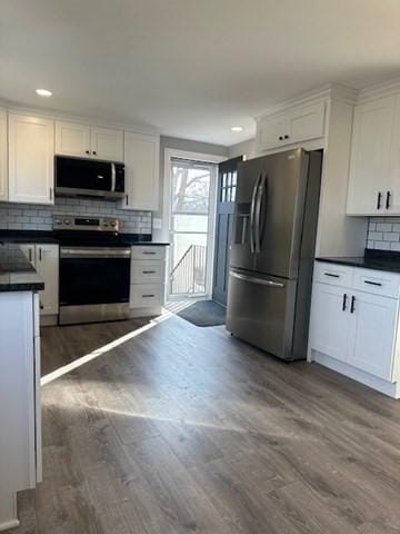 kitchen featuring white cabinetry, dark countertops, and stainless steel appliances