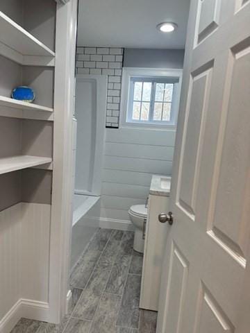 bathroom with wood finish floors and toilet