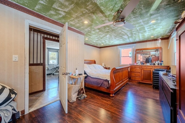 bedroom with dark wood-type flooring, ceiling fan, and ornamental molding