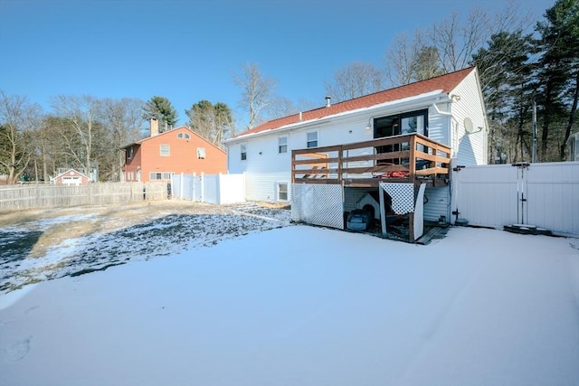 snow covered property featuring a deck