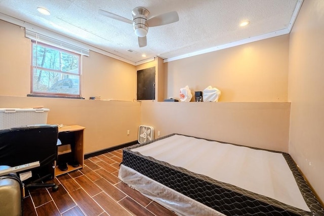 bedroom with ceiling fan, a textured ceiling, and crown molding