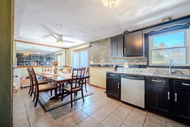 kitchen featuring dishwasher, light tile patterned floors, sink, backsplash, and ceiling fan