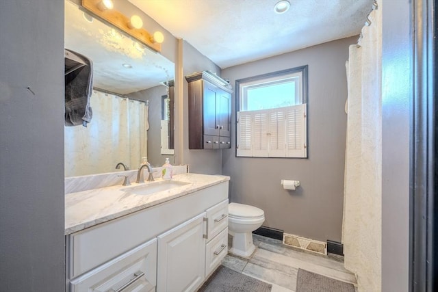 bathroom featuring vanity, toilet, and tile patterned floors