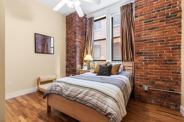 bedroom with baseboards, ceiling fan, and wood finished floors