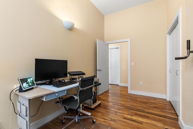 office area with baseboards and wood finished floors