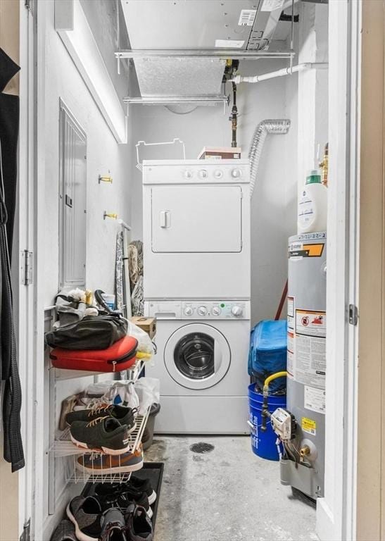 clothes washing area featuring laundry area, stacked washer and clothes dryer, water heater, and electric panel