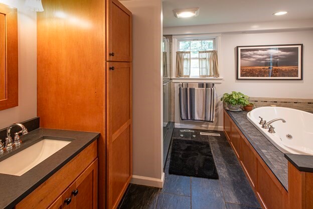 bathroom with a bathtub, vanity, and hardwood / wood-style flooring