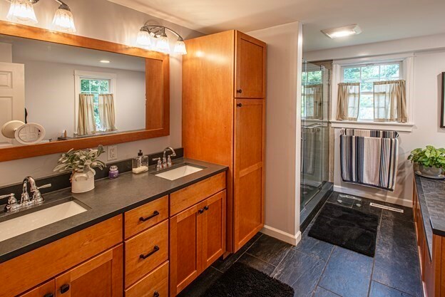 bathroom featuring vanity and a shower with shower door