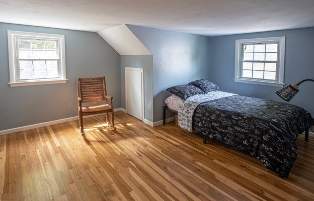 bedroom featuring multiple windows and hardwood / wood-style floors