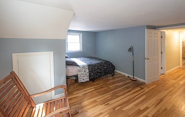 bedroom featuring lofted ceiling and light hardwood / wood-style floors