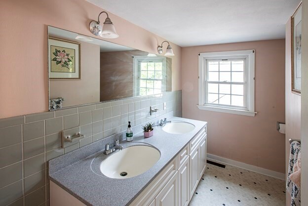 bathroom with vanity, tasteful backsplash, and a healthy amount of sunlight