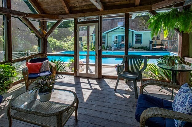 sunroom / solarium with vaulted ceiling with beams and wooden ceiling