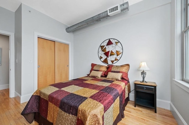 bedroom featuring a closet and light hardwood / wood-style flooring