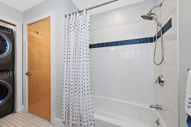 bathroom featuring stacked washer / drying machine, tile patterned flooring, and shower / bath combo with shower curtain