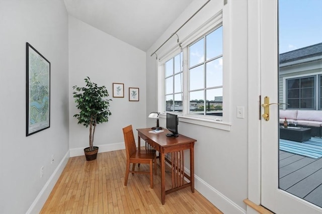 office area featuring vaulted ceiling and light hardwood / wood-style floors