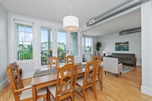 dining space with light hardwood / wood-style floors