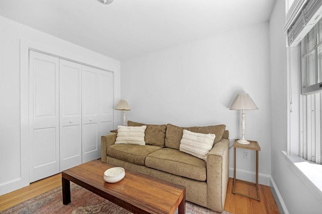 living room featuring light wood-type flooring and baseboards