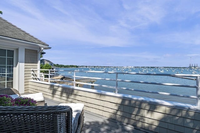 wooden terrace featuring a water view