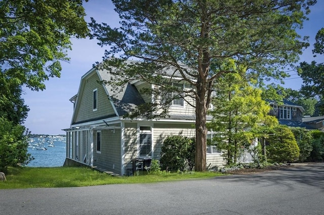view of side of home with a water view