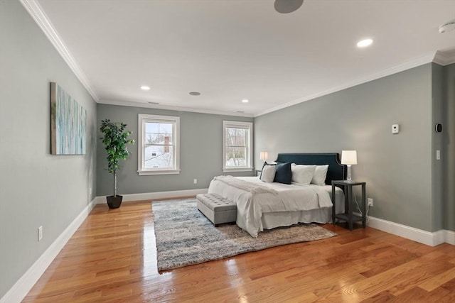 bedroom featuring light wood-style flooring, baseboards, and ornamental molding