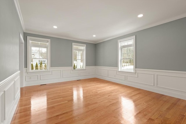 spare room with ornamental molding, recessed lighting, and light wood-style flooring