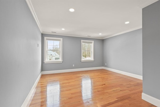 spare room featuring ornamental molding, light wood finished floors, recessed lighting, and baseboards