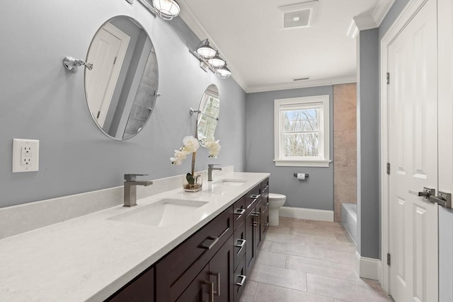 bathroom featuring double vanity, ornamental molding, a sink, and toilet