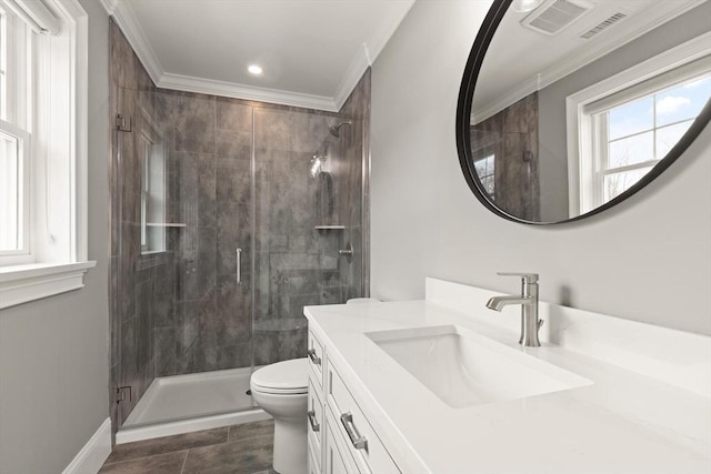 full bathroom featuring a stall shower, crown molding, vanity, and toilet