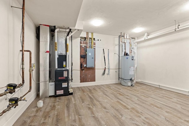 utility room featuring gas water heater, electric panel, and heating unit