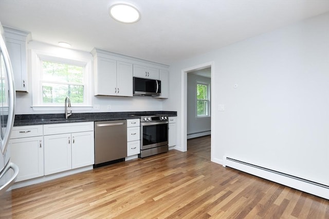 6 Post Gate Rd, Danvers, MA 01923 - kitchen featuring appliances with stainless steel finishes, a sink, baseboard heating, and plenty of natural light