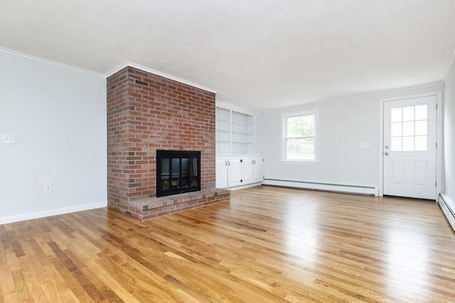 6 Post Gate Rd, Danvers, MA 01923 - unfurnished living room with baseboard heating, wood finished floors, ornamental molding, a brick fireplace, and built in shelves
