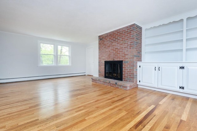 6 Post Gate Rd, Danvers, MA 01923 - unfurnished living room featuring a baseboard heating unit, light wood-style floors, a fireplace, crown molding, and built in shelves