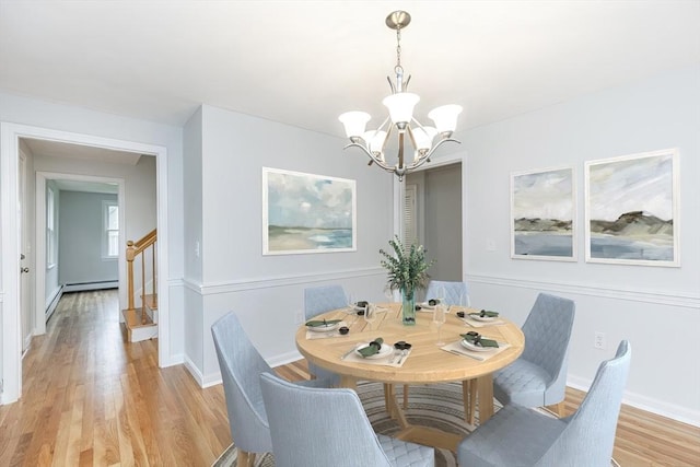 6 Post Gate Rd, Danvers, MA 01923 - dining space featuring a chandelier, stairs, light wood-style floors, and baseboards