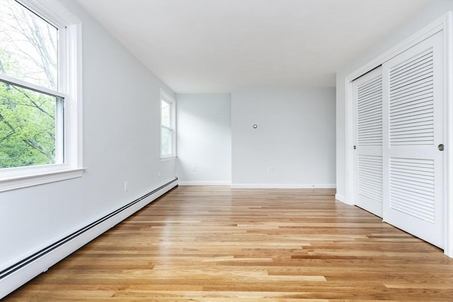 6 Post Gate Rd, Danvers, MA 01923 - unfurnished bedroom with baseboard heating, light wood finished floors, multiple windows, and a closet