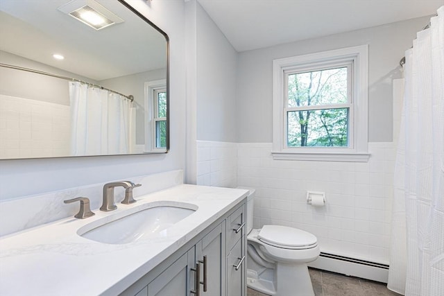 6 Post Gate Rd, Danvers, MA 01923 - full bathroom with baseboard heating, tile walls, toilet, vanity, and a wainscoted wall