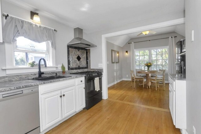 kitchen featuring lofted ceiling, range hood, a sink, dishwasher, and black gas range oven
