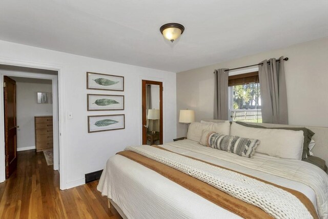 bedroom featuring baseboards and wood finished floors