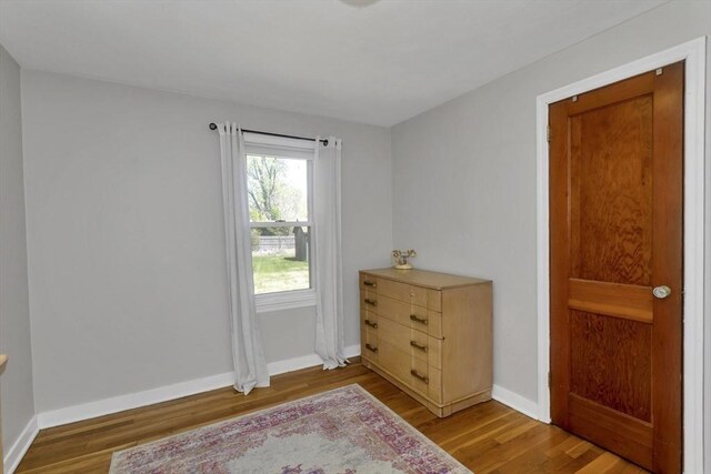 interior space with baseboards and light wood-type flooring