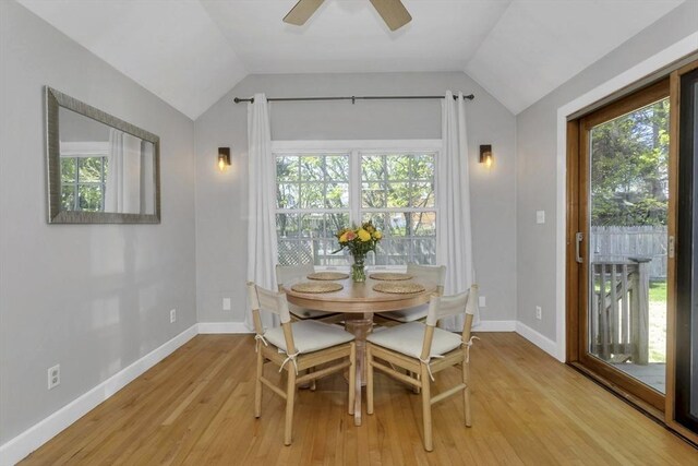 dining room with baseboards, ceiling fan, lofted ceiling, and light wood-type flooring