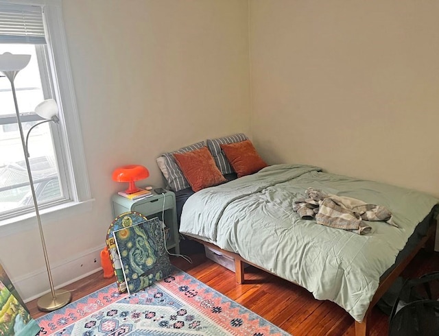 bedroom with wood-type flooring